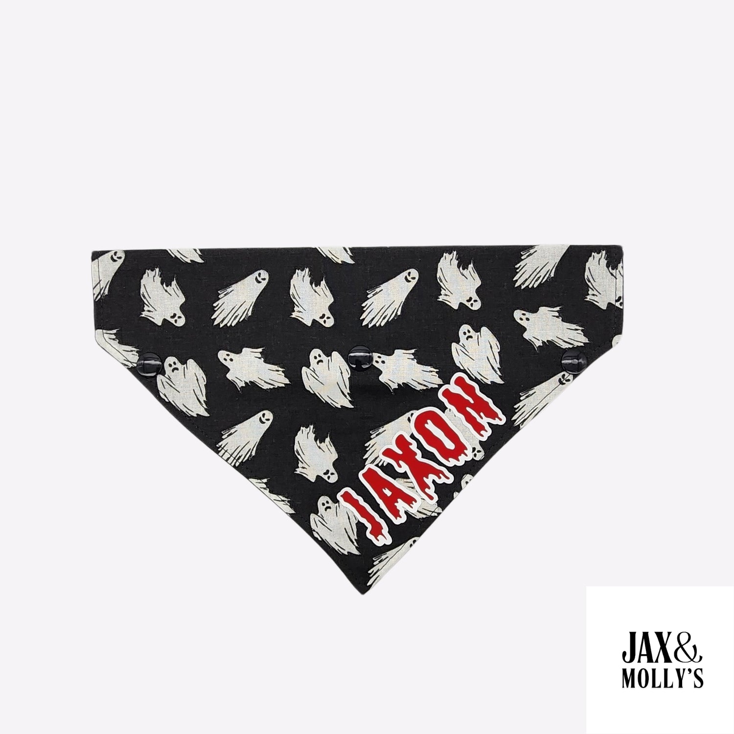 A Halloween over the collar, dog bandana, with flying ghosts on a black background with the vinyl graphic Jaxon in red and white.