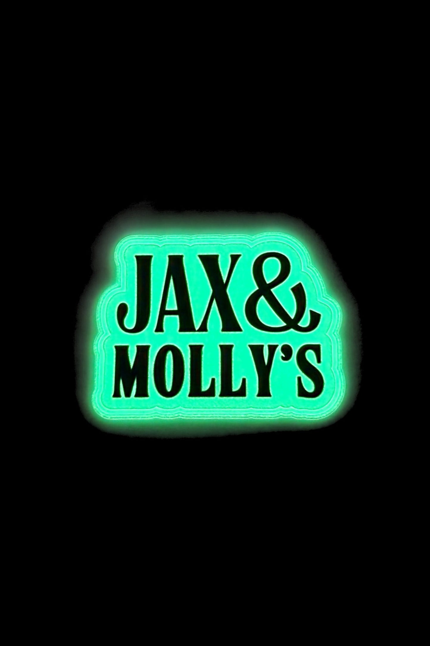 Glow-in-the-dark Jax & Molly's' clothing label on a black background
