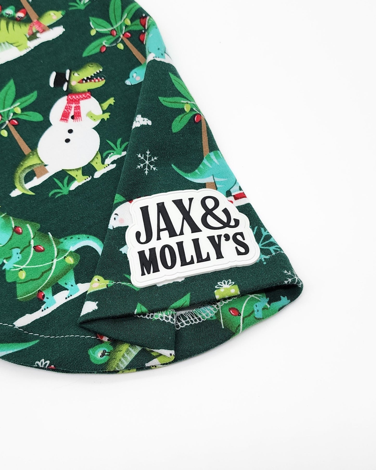 Close-up of green dinosaur Christmas dog cotton fabric