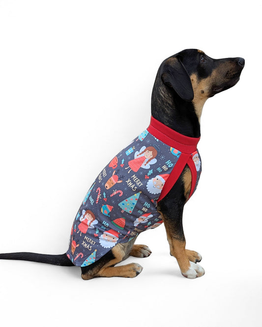 Side view of dog in lightweight Christmas tank, gray with Santa, angels, trees and ‘Ho Ho Ho’ print, red trim