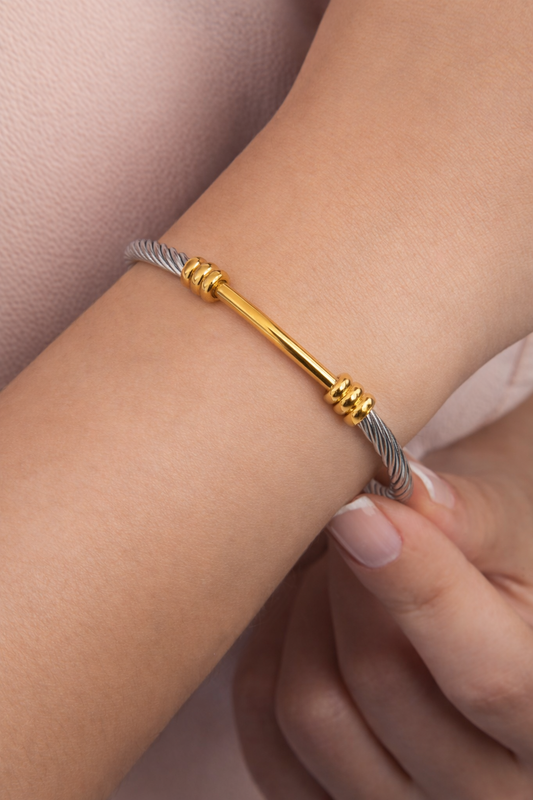 Cable cuff bracelet stainless steel and 18K gold two-tone bracelet on woman’s wrist lifestyle photo