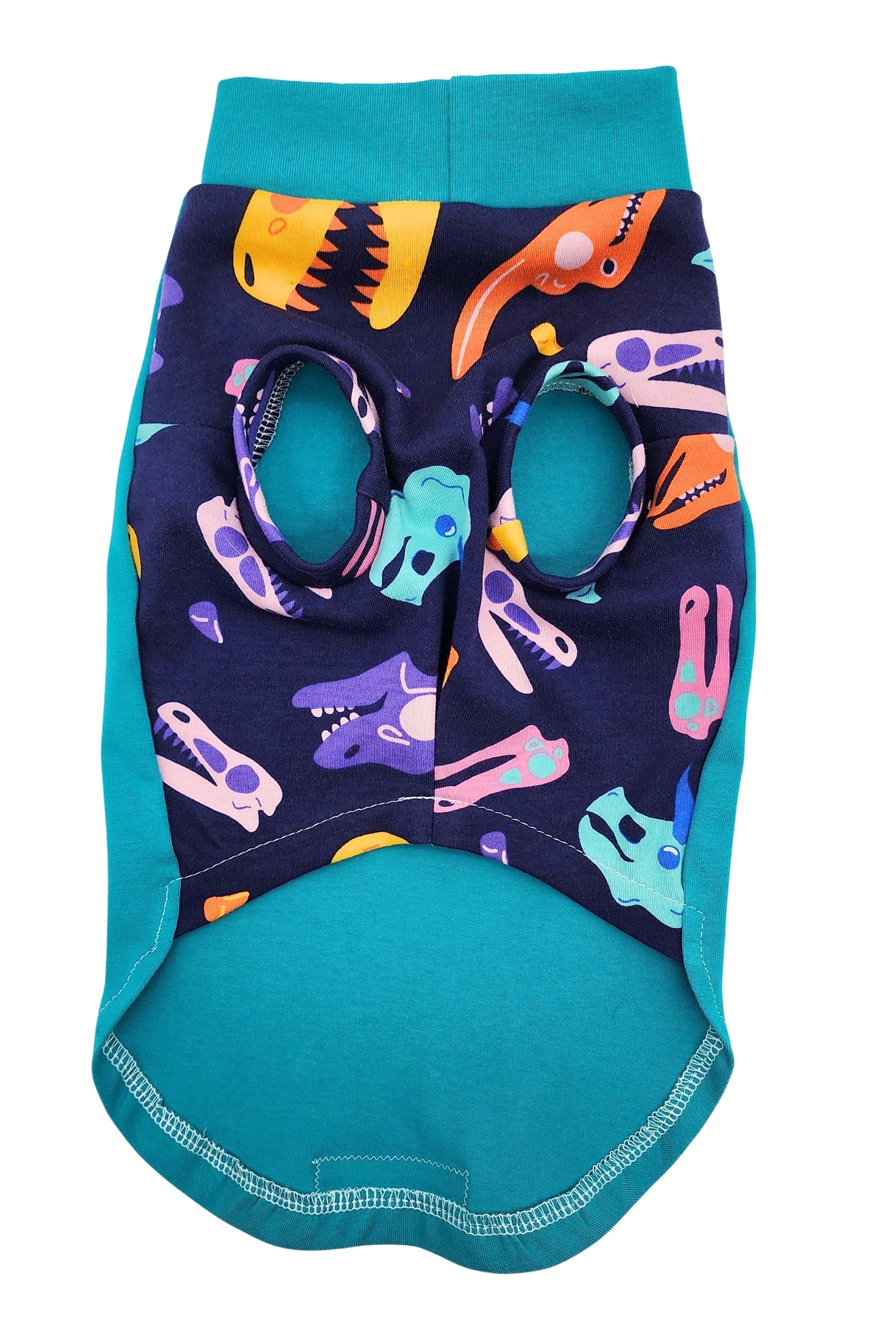 Dog shirt with teal trim and navy underbelly featuring colorful dinosaur skull pattern