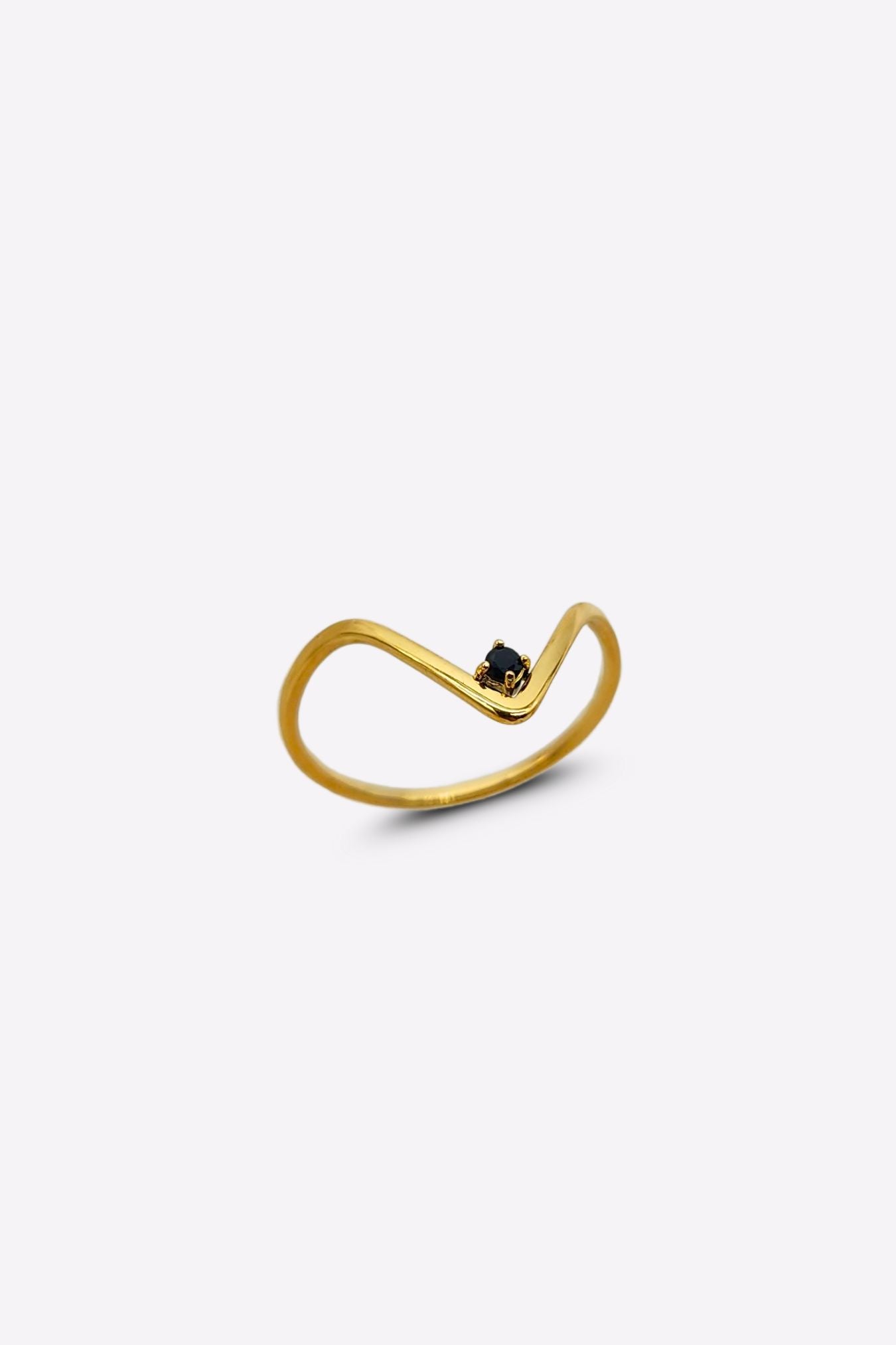 Thin v-shaped gold ring with black onyx stone at the tip.