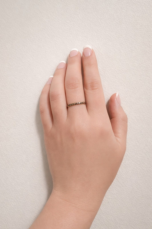 Black enamel filigree 18k PVD gold plated stainless steel band ring worn on finger minimal hand model neutral background