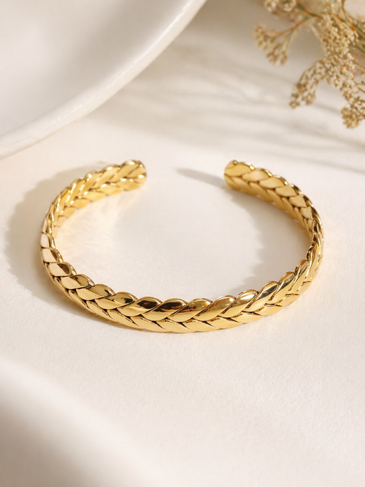 braided gold stainless steel cuff bracelet woven texture open bangle flat lay