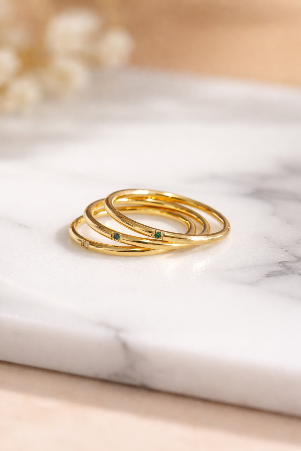 tri color gemstone gold stacking rings 18k pvd stainless steel angled stack close up marble surface