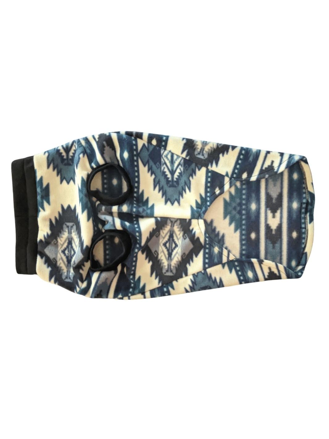 Underbelly display of a blue and off-white aztec print dog sweater displaying its black neck and sleeve trim.