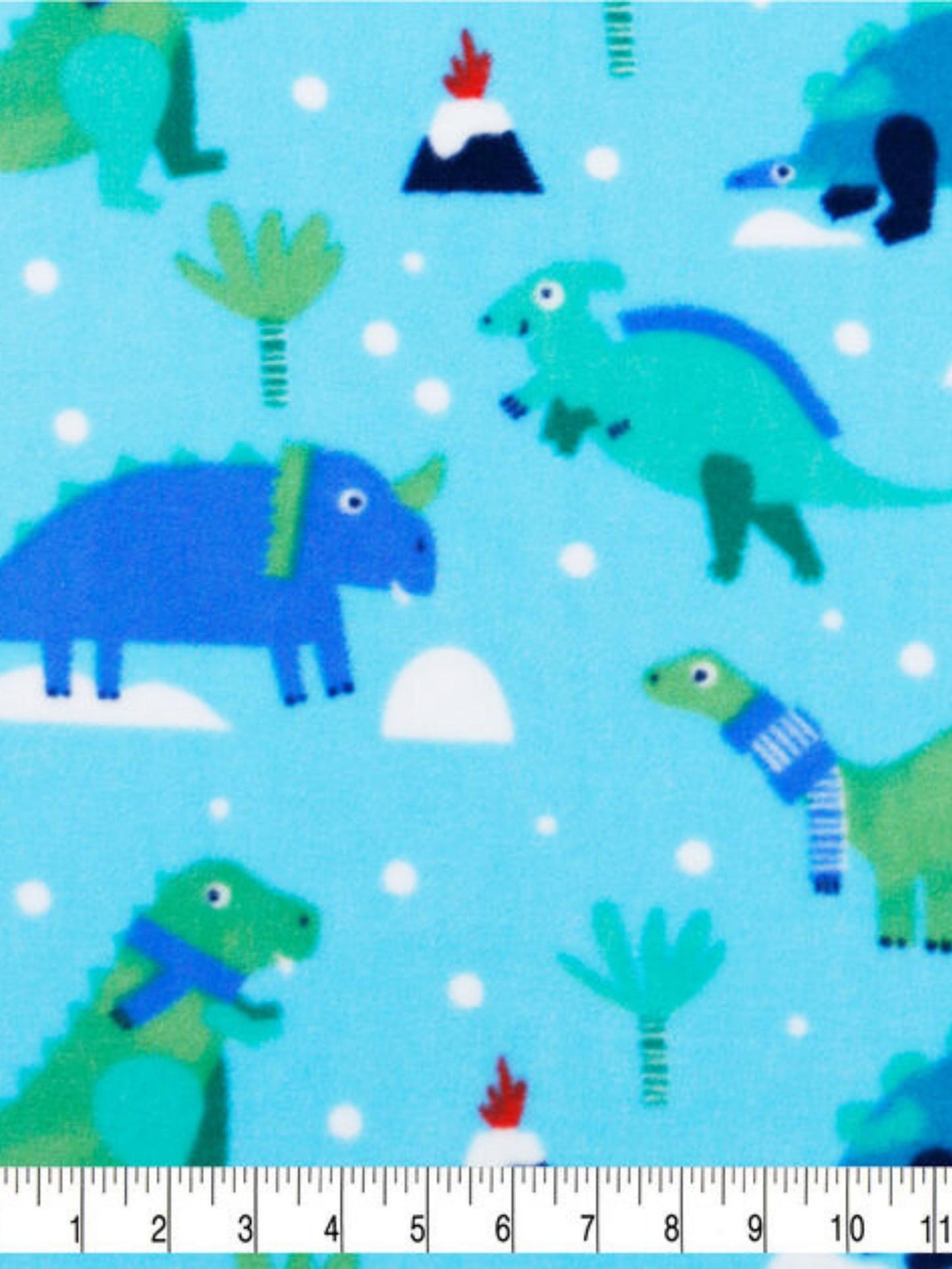 Blue fleece fabric with a dinosaur print and measuring tape displaying size of the print