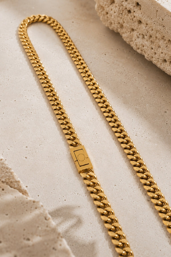 Close-up of the JAX & MOLLY'S signature clasp on the 8mm Cuban Link 18K Gold PVD Necklace.
