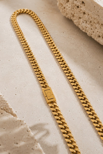 Close-up of the JAX & MOLLY'S signature clasp on the 8mm Cuban Link 18K Gold PVD Necklace.