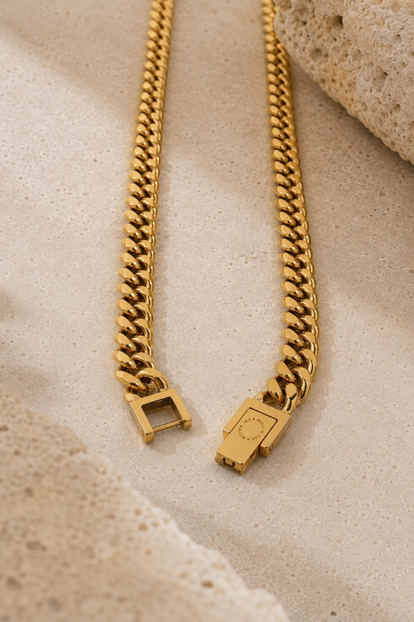 Close-up of the open box clasp on the 8mm Cuban Link 18K Gold PVD Necklace showing the secure locking mechanism and engraved JAX & MOLLY'S logo.