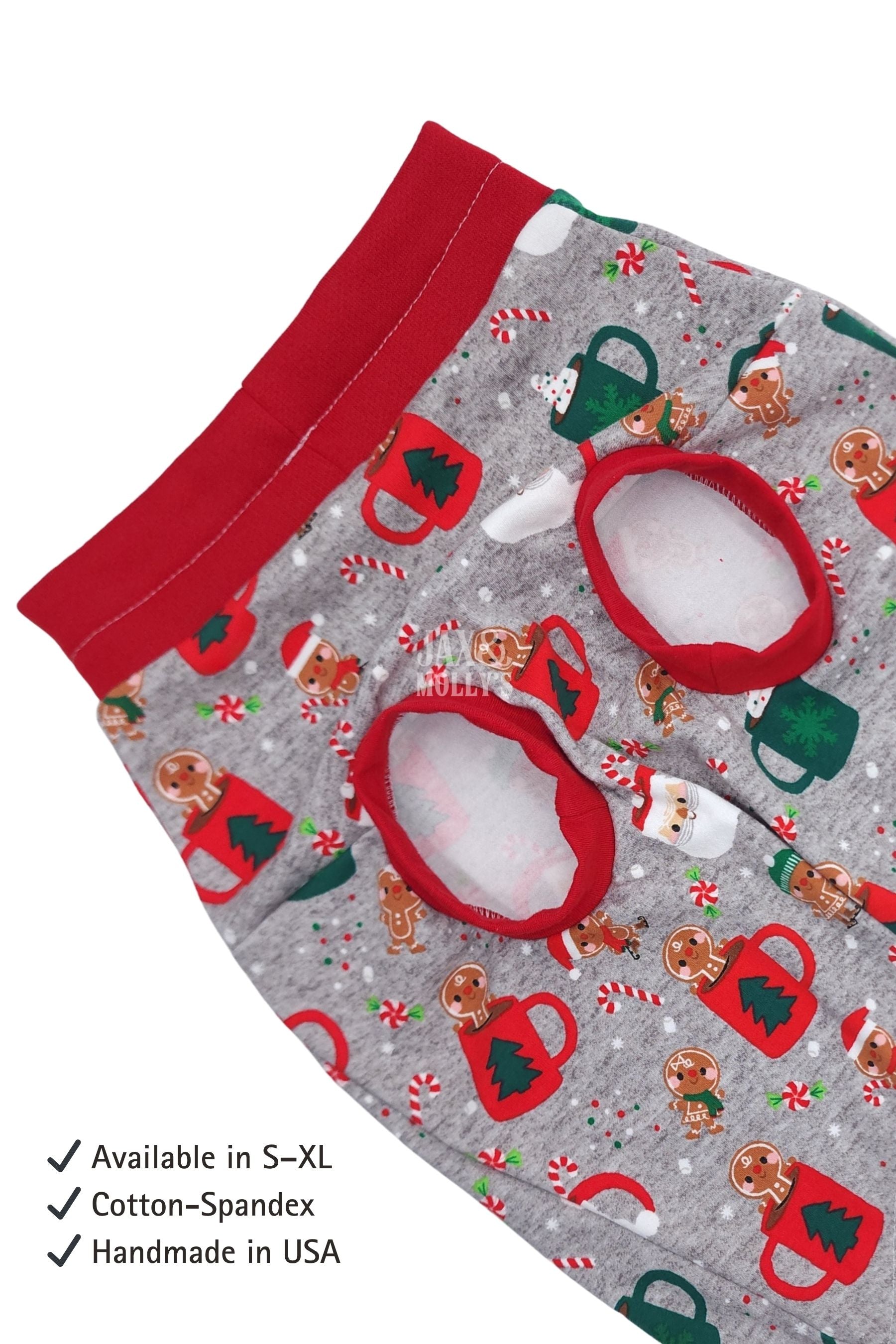 Christmas-themed dog pajamas with gingerbread men, candy canes, and mugs on a gray background.