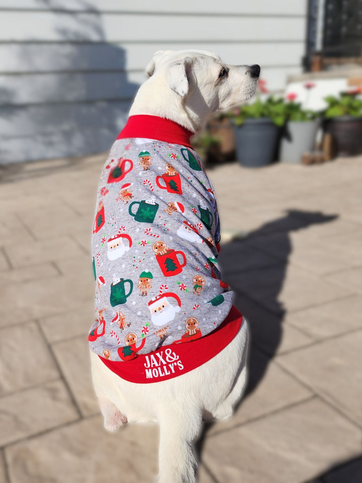 Adorable dog modeling Jax & Molly's Christmas Mug Dog Pajamas showcasing Christmas mugs with Santa, gingerbread cookies, candy canes, and more holiday accents on a charming gray background.