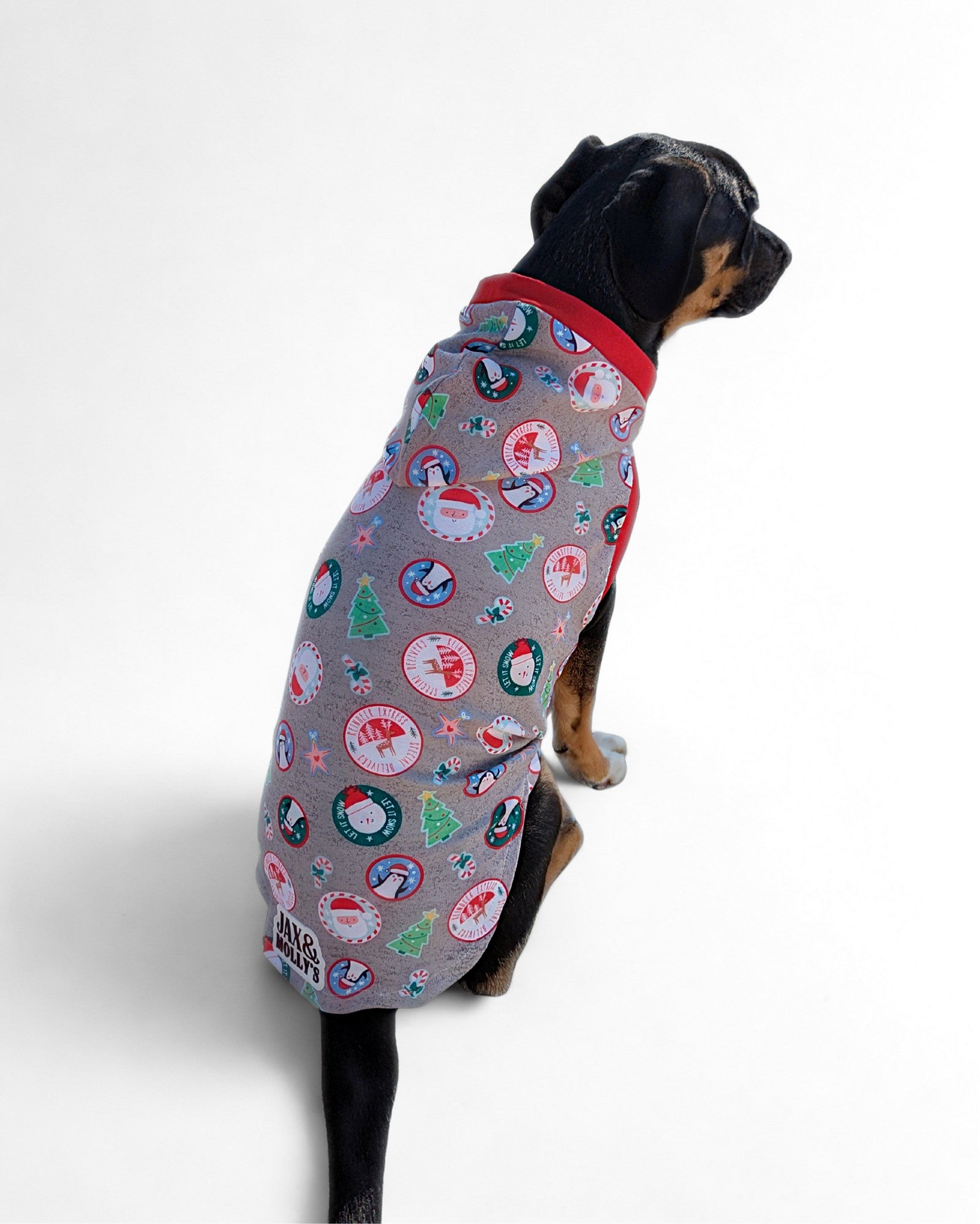 Back view of dog wearing grey Christmas dog pajama with hood and red trim by Jax & Molly’s