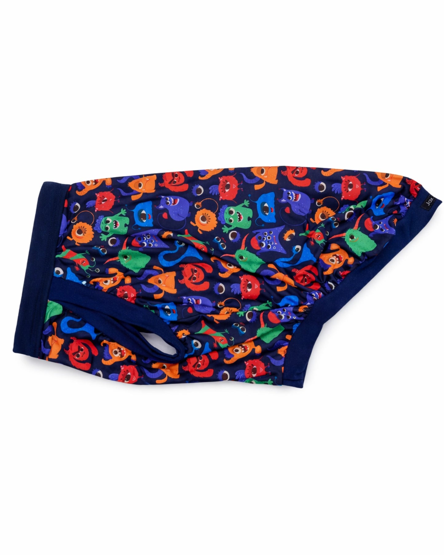 Colorful Monster Comrades dog pajamas with navy trim, side view highlighting stretchy sleepwear design