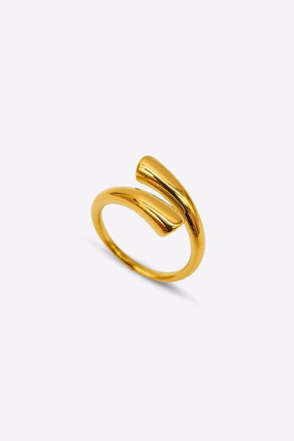 Highly polished, adjustable gold cuff ring on display.