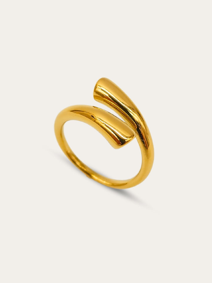 Highly polished, adjustable gold cuff ring on display.