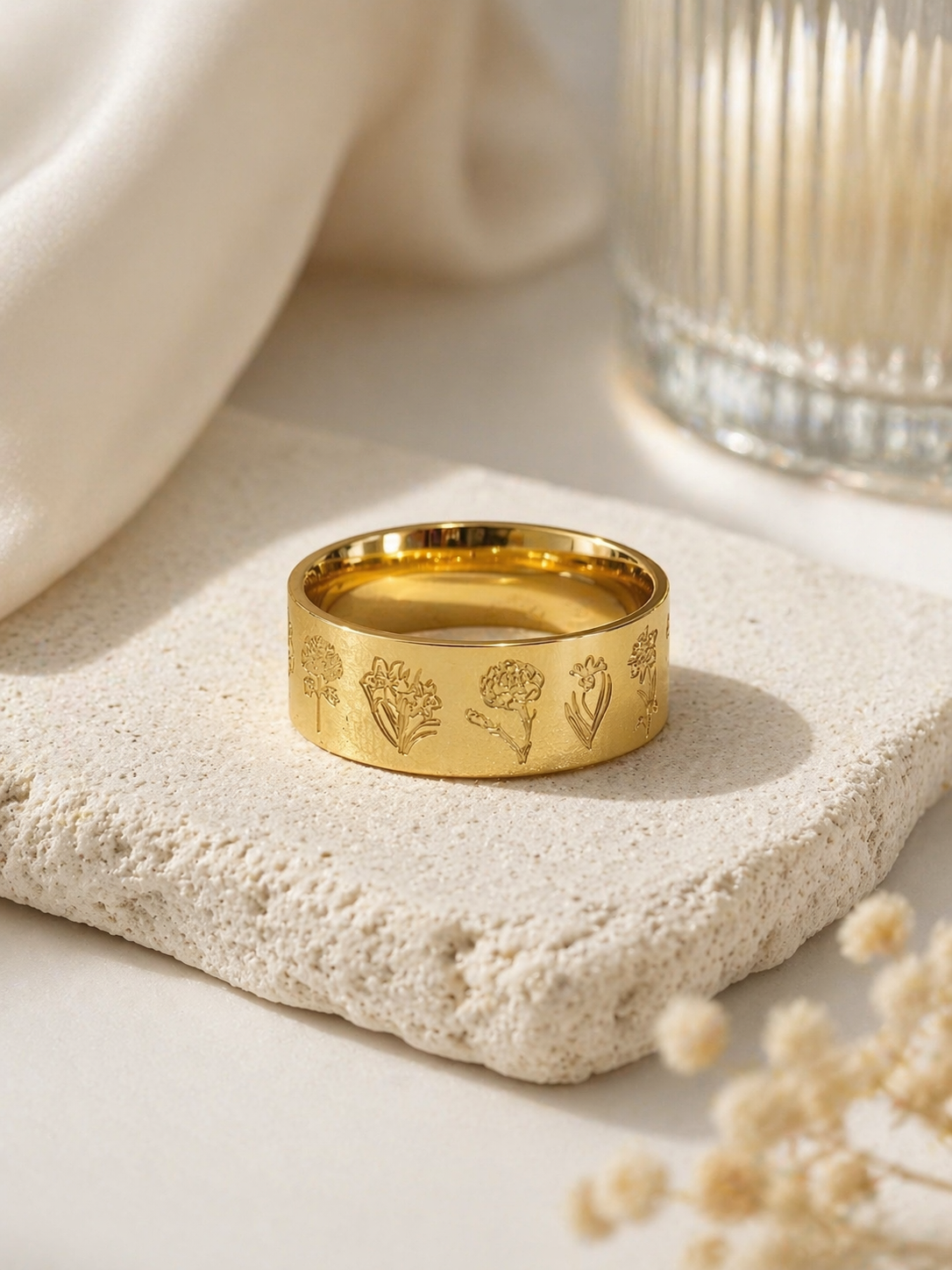 floral engraved gold ring wide band flat lay botanical design neutral background