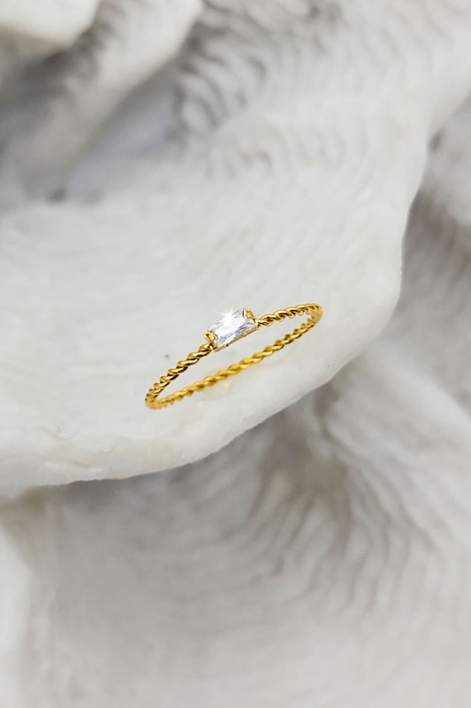 Jax & Molly's 18K Gold PVD Plated Rectangular Gemstone Ring with Twisted Band on a white coral display.