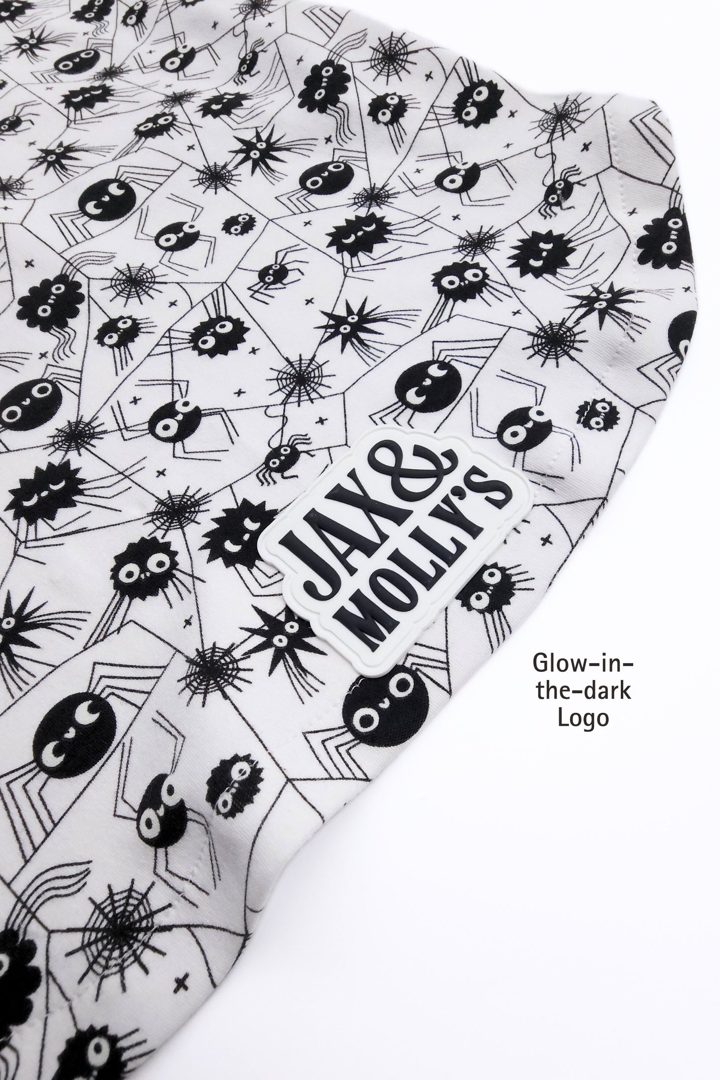 Product with black and white spider pattern and 'Jax & Molly's' text on a white background