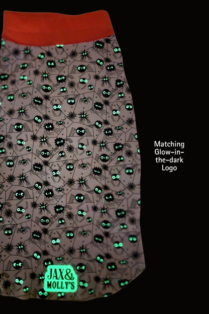 Halloween dog jammies with spider pattern and 'Jax & Mollys' branding, glow-in-the-dark effect.