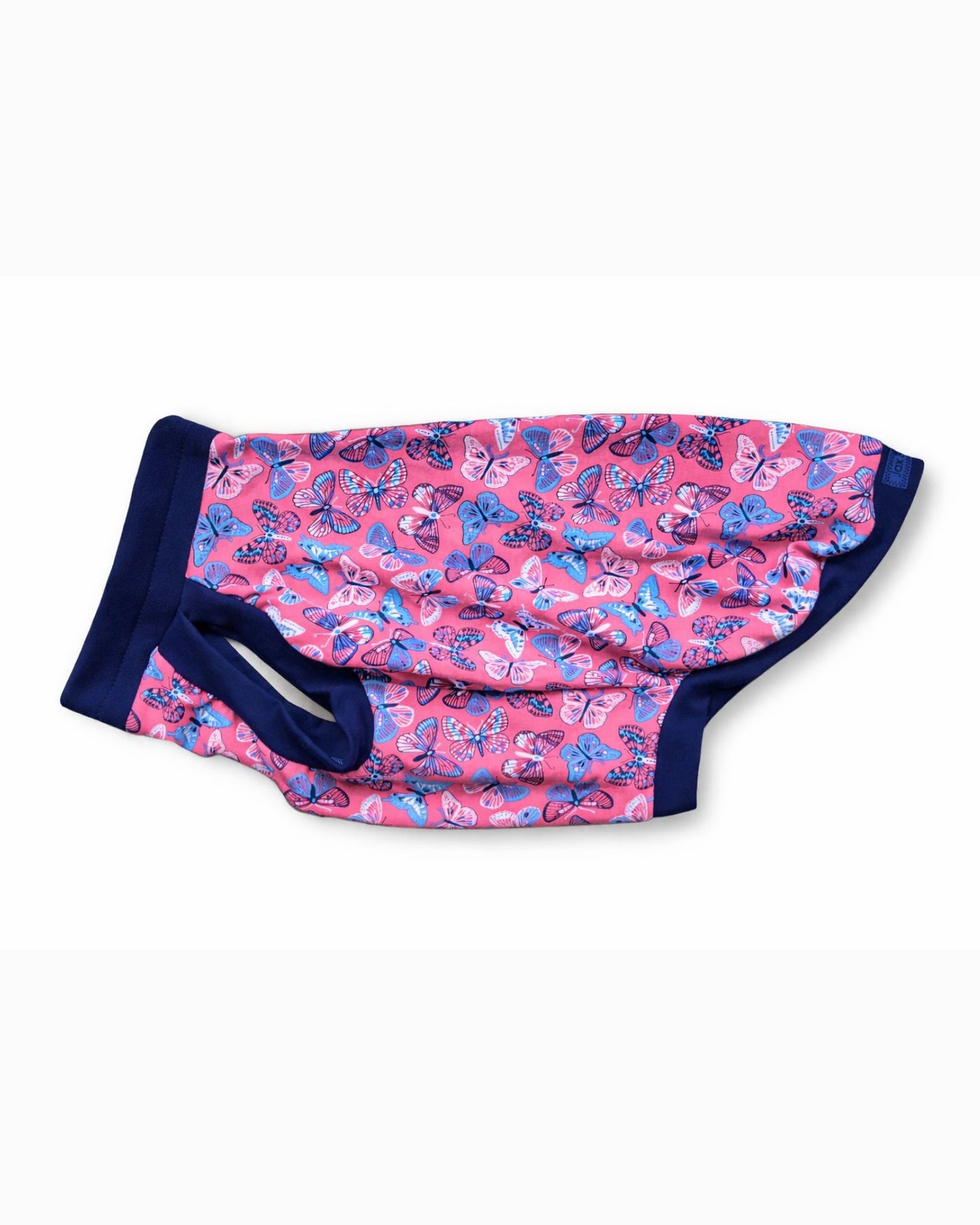 Side view of pink dog pajamas with butterfly print with navy trim