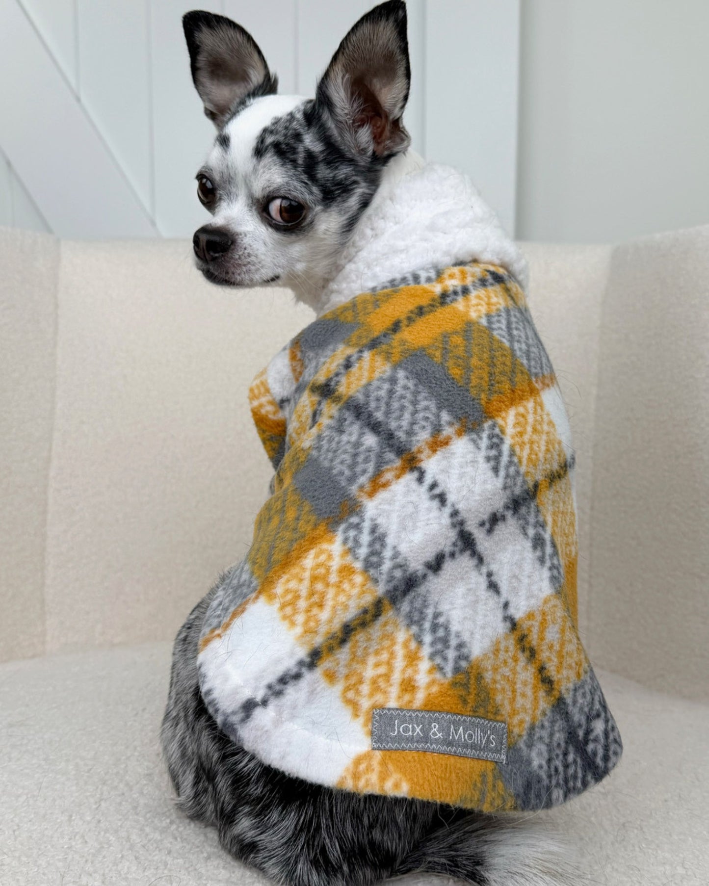 Back view of dog in cozy plaid fleece dog sweater with white sherpa neck