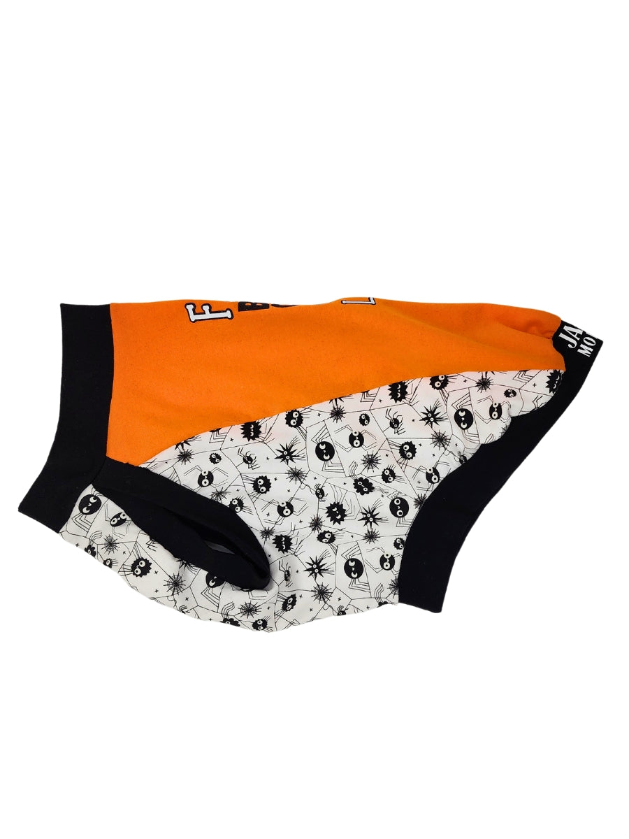 Side view of an orange Halloween-themed dog muscle tank with Fab-Boo-Lous written on the back of shirt with a glow-in-the-dark spider print underbelly, and black trim for the neck, sleeves, and waistband.