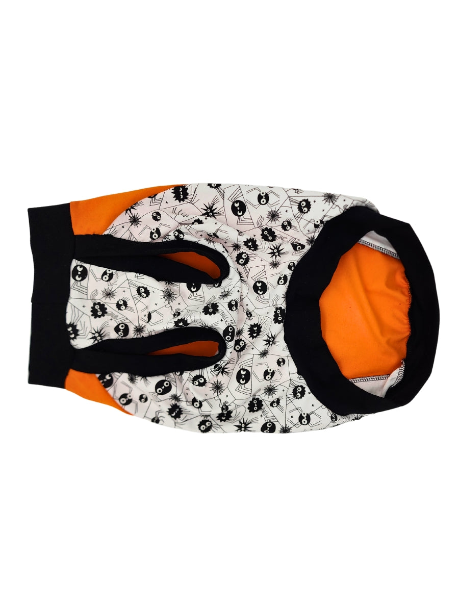 Underbelly view of an orange Halloween-themed dog muscle tank with Fab-Boo-Lous written on the back of shirt with a glow-in-the-dark spider print underbelly, and black trim for the neck, sleeves, and waistband.
