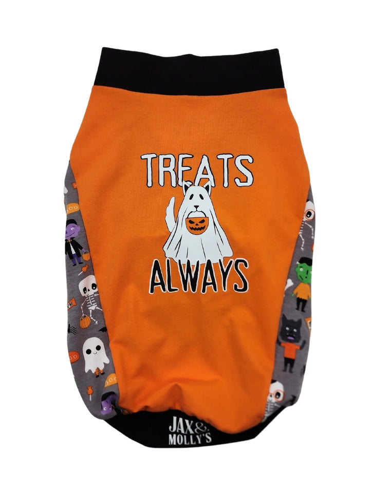 An orange Halloween-themed dog muscle tank featuring the words Treats Always and an image of a dog dressed in a ghost sheet, monster-print underbelly, and black trim for the neck, sleeves, and waistband.