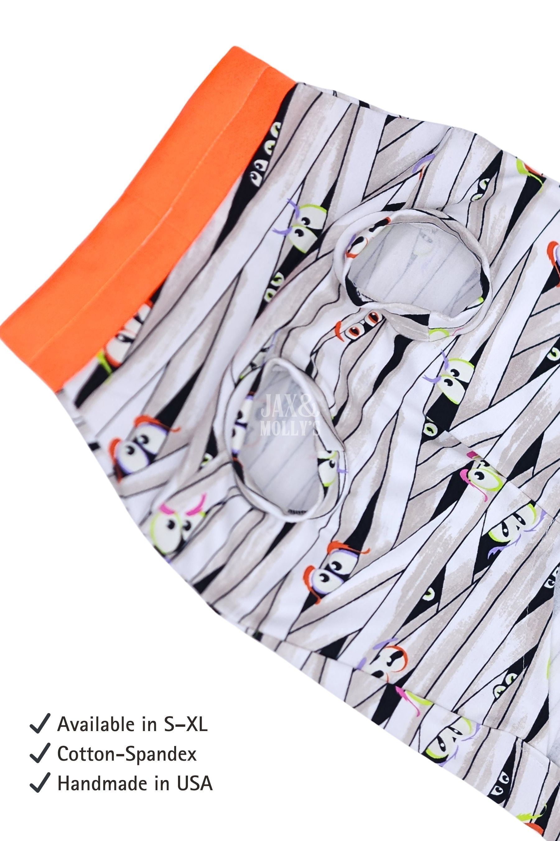 Glow-in-the-dark Halloween dog pajamas with mummy wrap print and orange trim featuring text about product details.