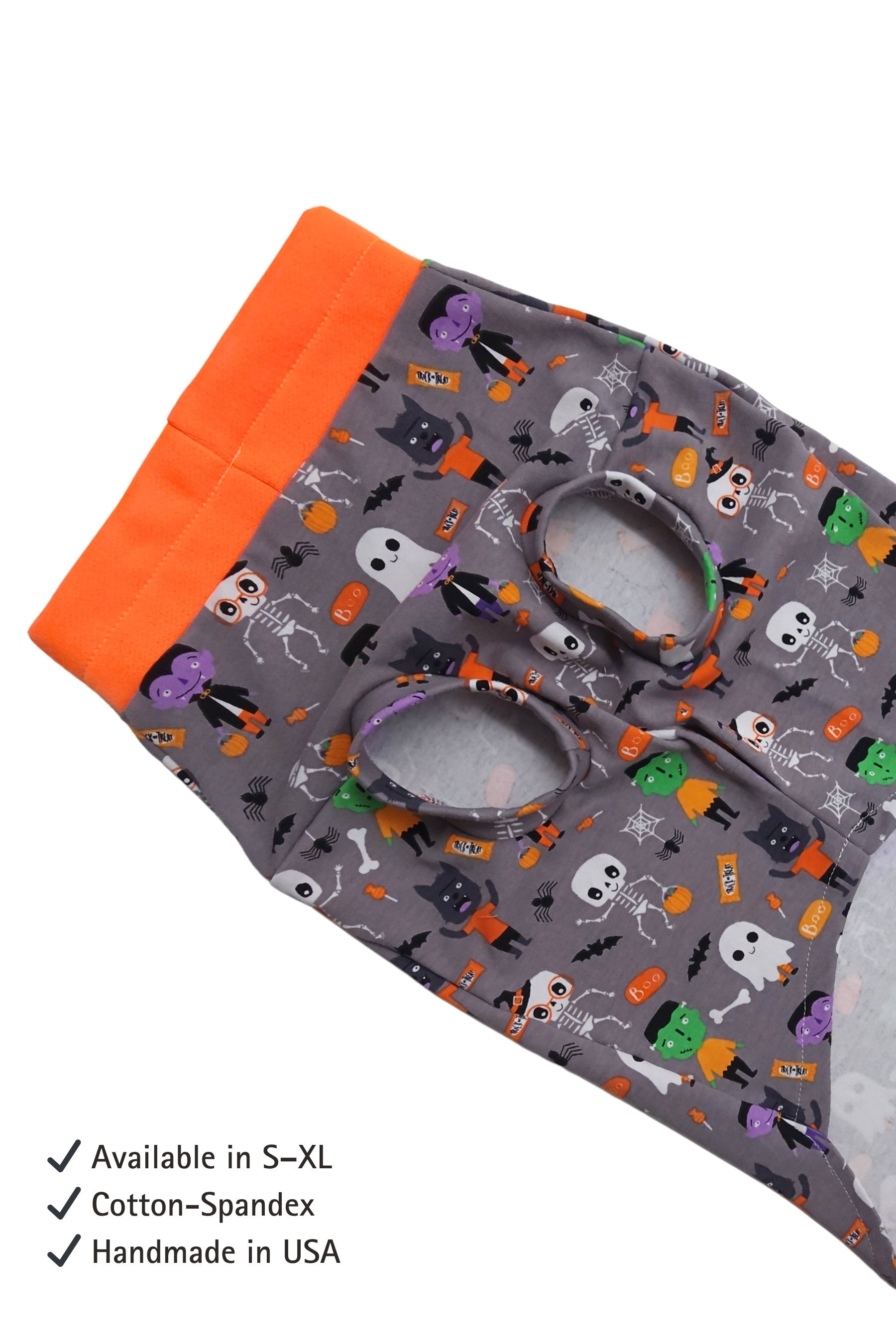 Halloween-themed fabric with orange border and text indicating size availability, material, and origin.