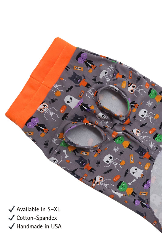 Halloween-themed fabric with orange border and text indicating size availability, material, and origin.
