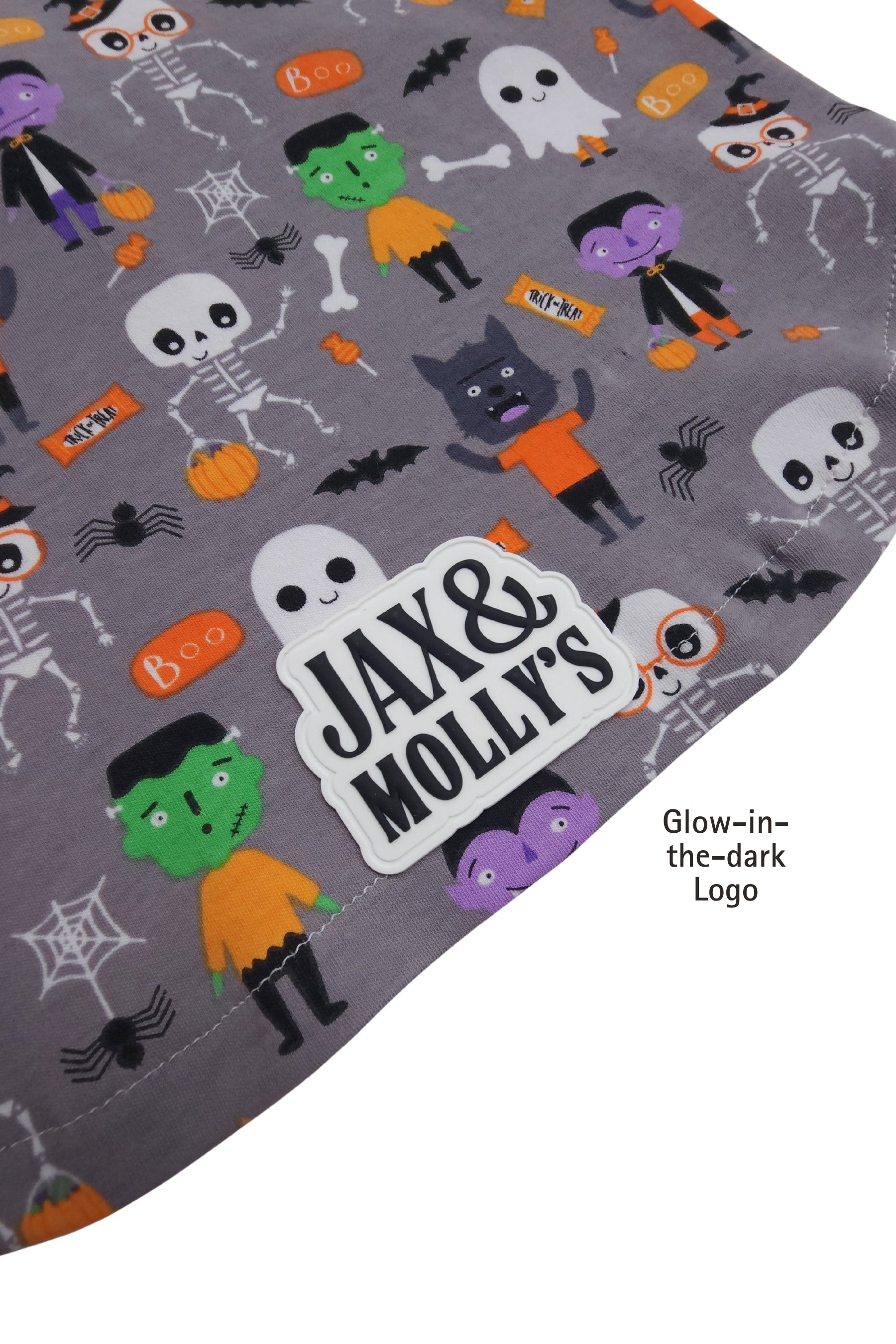 Halloween-themed fabric with cartoon characters and 'Jax & Molly's' logo on a gray background.