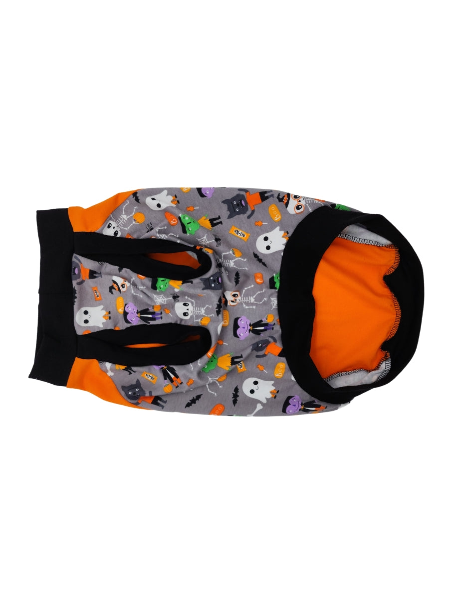 Underbelly view of an orange Halloween-themed dog muscle tank featuring the words Treats Always and an image of a dog dressed in a ghost sheet, monster-print underbelly, and black trim for the neck, sleeves, and waistband.