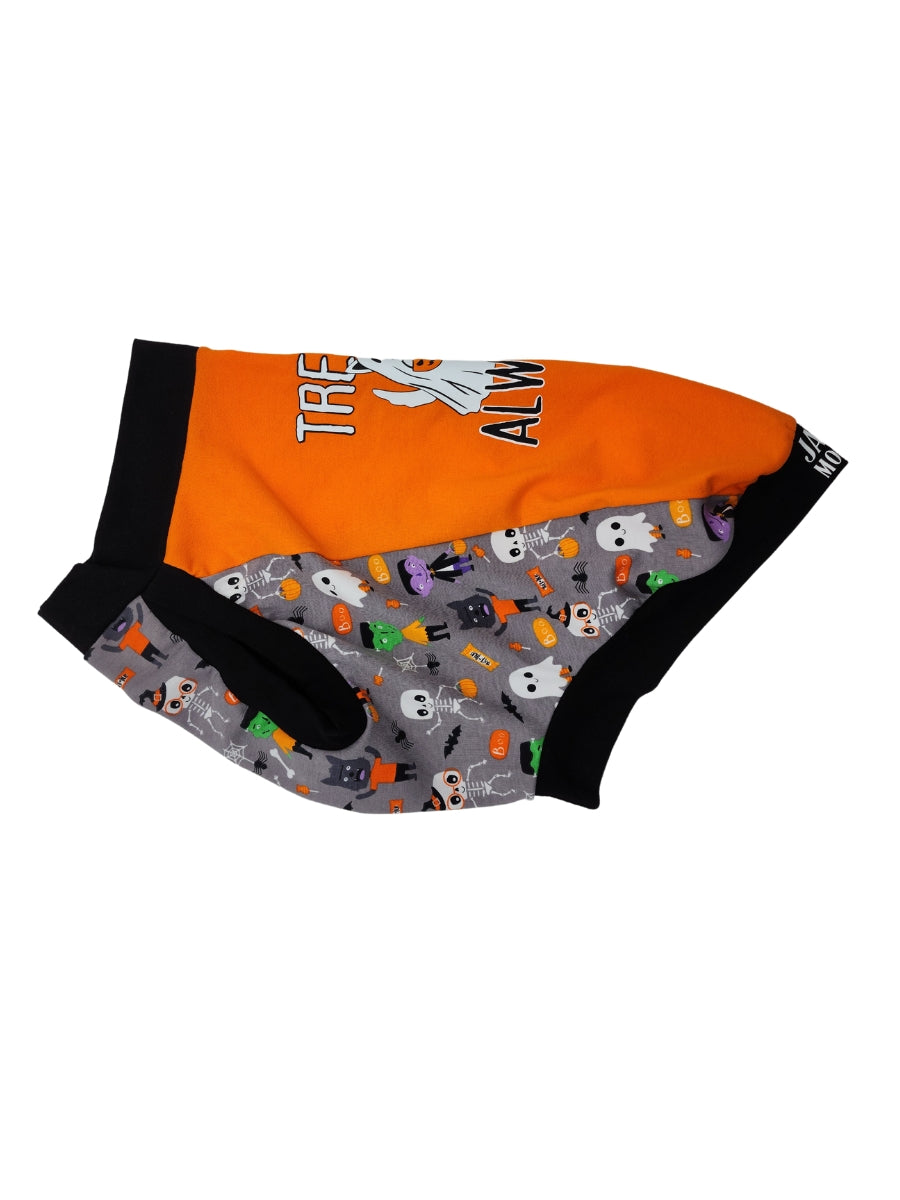 Side view of an orange Halloween-themed dog muscle tank featuring the words Treats Always and an image of a dog dressed in a ghost sheet, monster-print underbelly, and black trim for the neck, sleeves, and waistband.