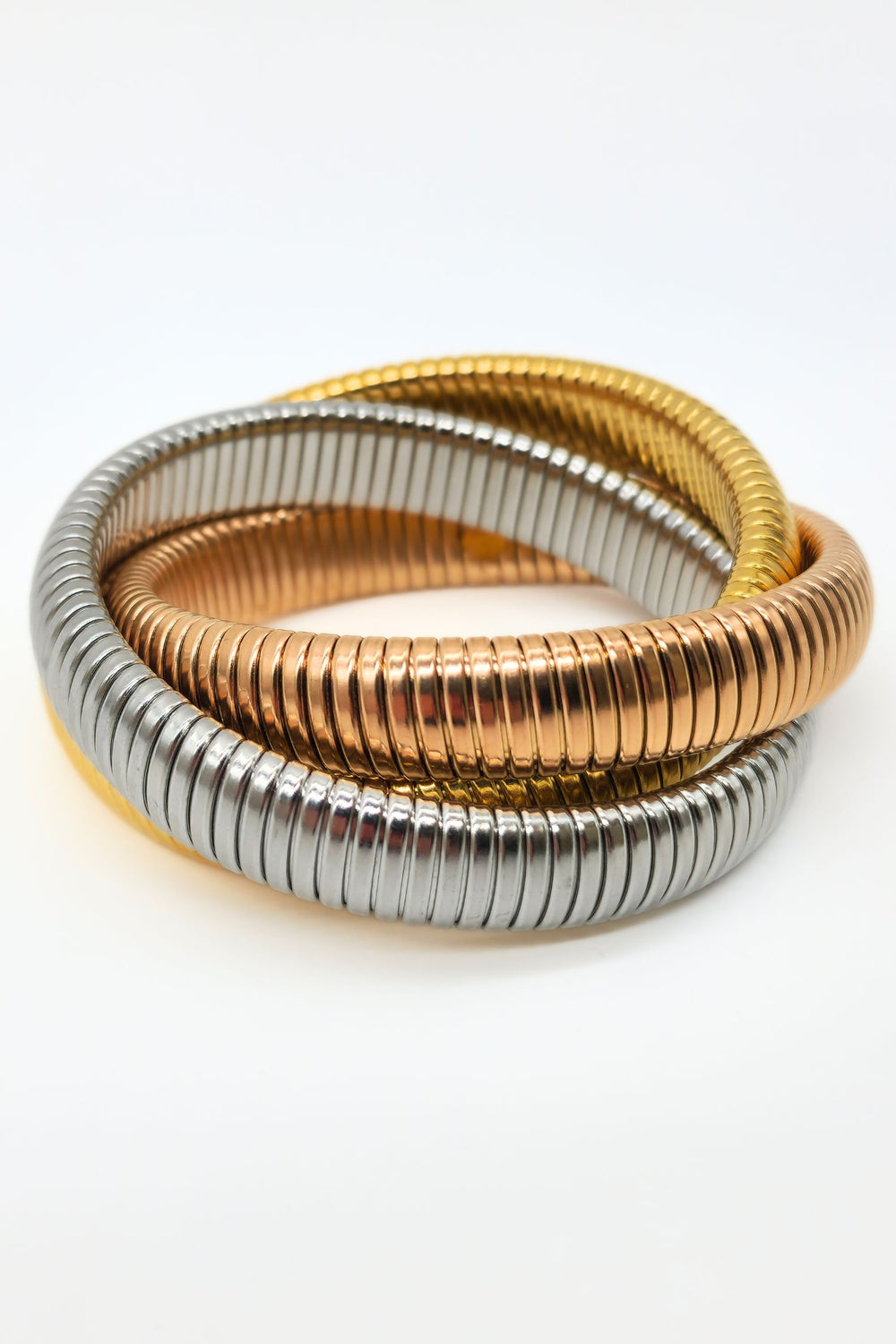 Jax & Molly's captivating set of three interlinked stretch snake bracelets in steel, rose gold, and gold.