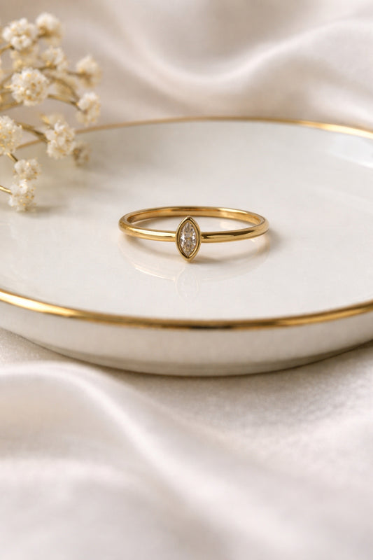 Minimalist marquise gold ring 18k PVD stainless steel ring on ceramic dish soft neutral styling