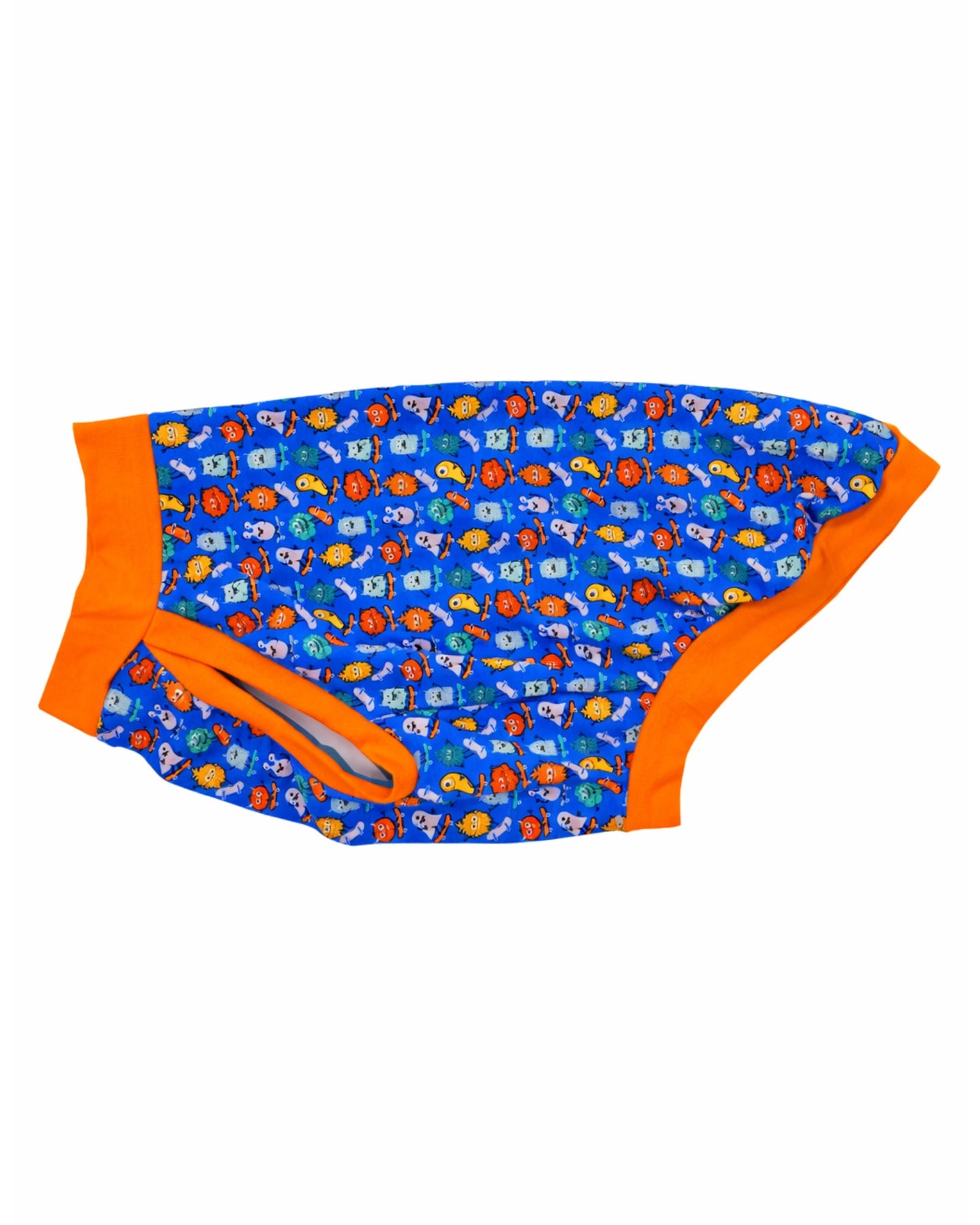 Side view of Jax & Molly's dog pajamas featuring a colorful monster print on skateboards with orange trim