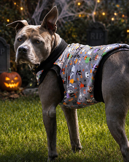 Side view of a gray pit bull wearing Monster Squad Halloween dog pajamas in the Muscle Tank style with black trim.