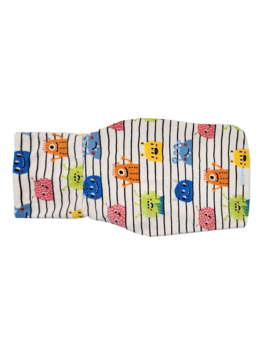 Backside of a fleece dog sweater with a colorful print of monsters