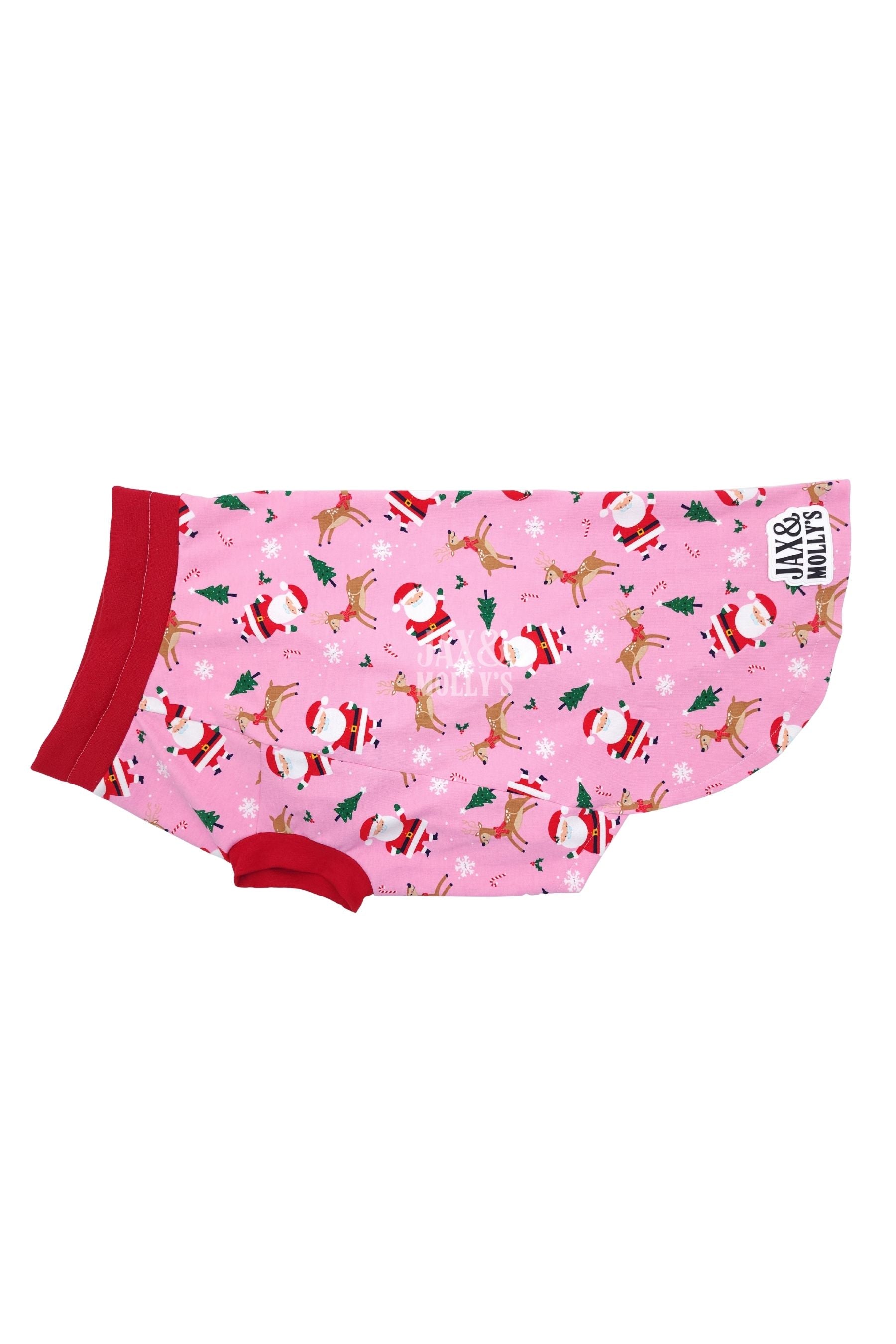 Christmas-themed dog pajamas with Santa Claus, reindeer, and seasonal accents on pink background.