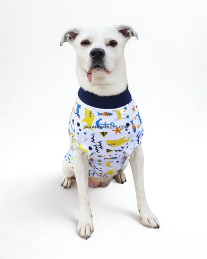 Playful Fish & Sharks cotton-spandex dog pajamas on white dog, sitting