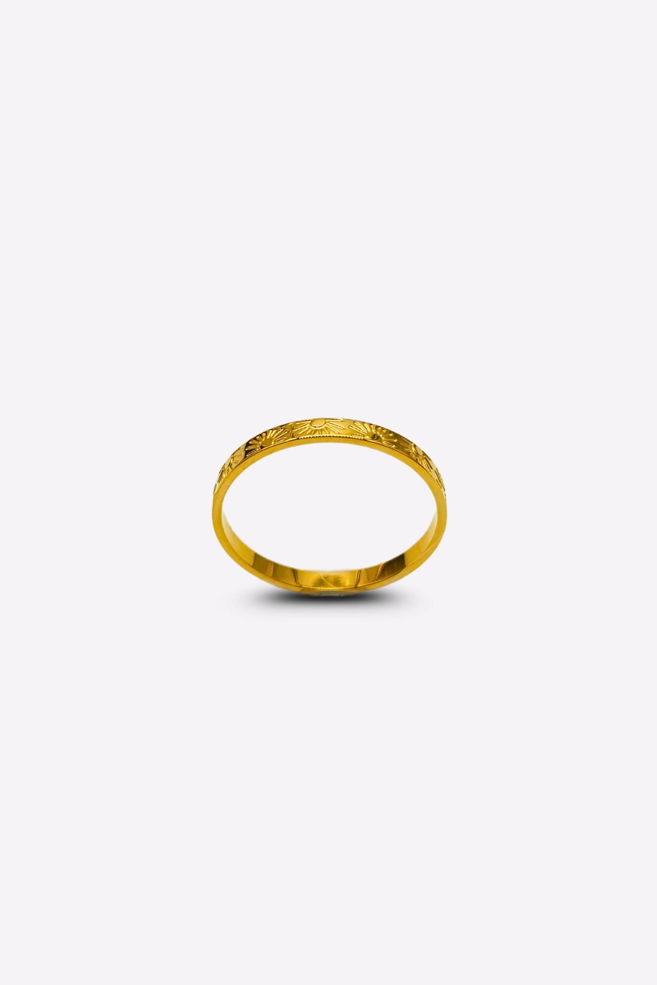 Elegant gold ring featuring sun and ray inscriptions, captured from a front angle on a white background.