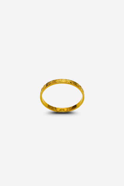 Elegant gold ring featuring sun and ray inscriptions, captured from a front angle on a white background.