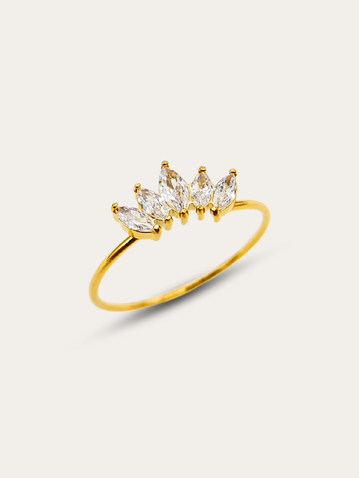 Gold ring with 5 clear gemstones arranged in a crown-like design on a delicate thin 18k PVD gold plated stainless steel band, displayed on a white background.