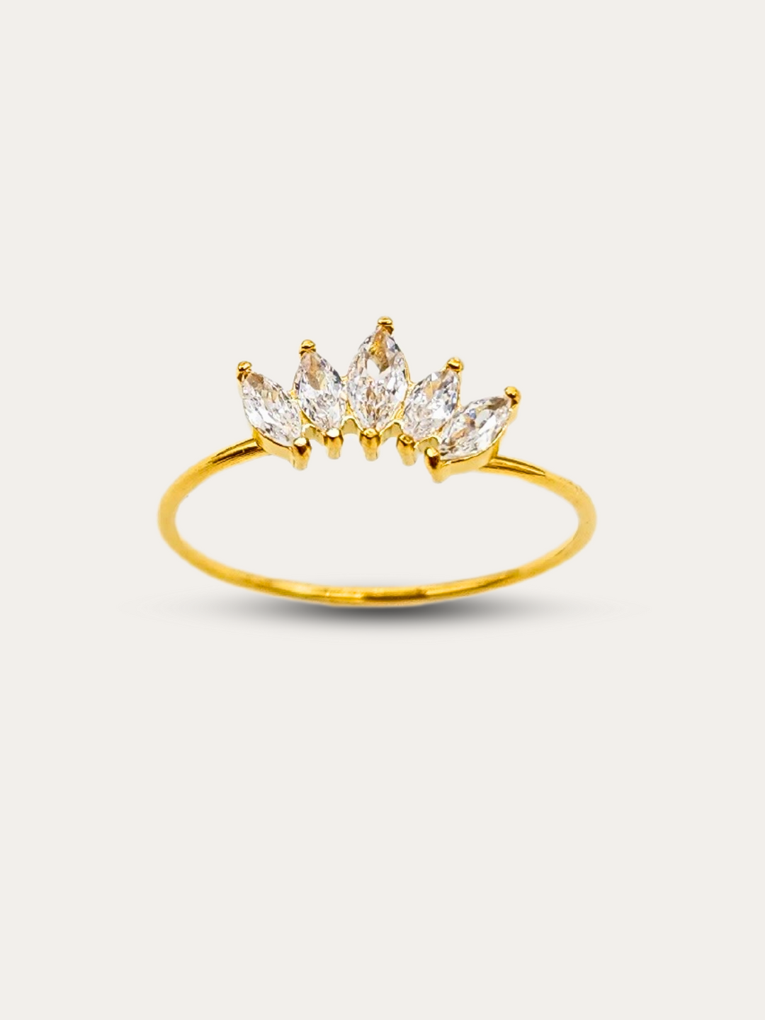 Elegant ring showcasing 5 brilliant clear gemstones set on a crown-inspired, thin gold band, presented against a white backdrop to highlight its beauty.