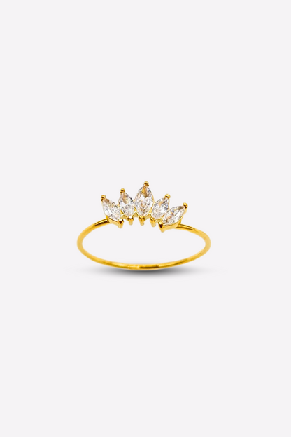 Elegant ring showcasing 5 brilliant clear gemstones set on a crown-inspired, thin gold band, presented against a white backdrop to highlight its beauty.