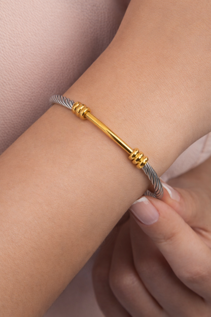 Cable cuff bracelet stainless steel and 18K gold two-tone bracelet on woman’s wrist lifestyle photo