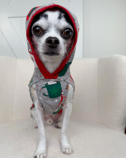 Dog wearing festive Santa cocoa print hoodie with red hood trim
